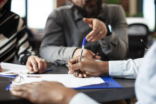 Black person signing job contract